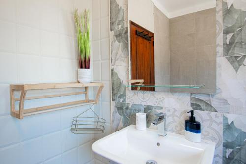 a bathroom with a sink and a mirror at Ufitness Villa Algarve in Vila Real de Santo António