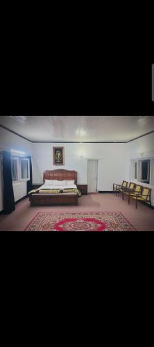a large room with a bed and a couch at DREAM LAND cottage in Abbottabad