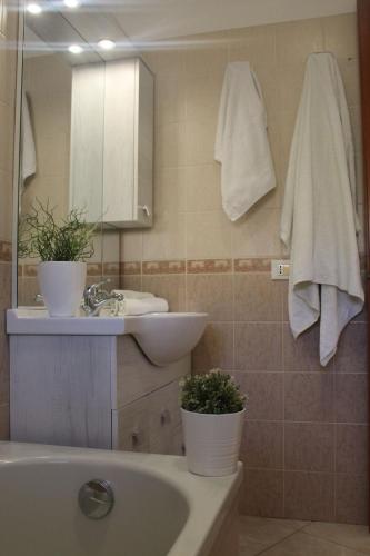 a bathroom with a tub and a sink and a mirror at Casa Elena Floris in Teulada