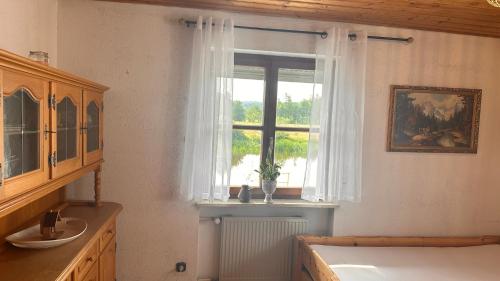 a room with a window with a radiator at Idyllische Ferienwohnungen Die Rustikale mit Blick auf die Naab in Burglengenfeld
