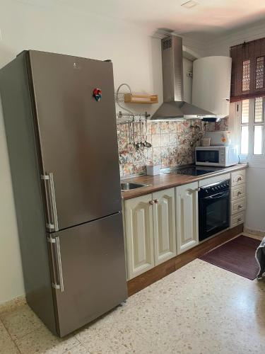 a kitchen with a stainless steel refrigerator at Sanpau in Vejer de la Frontera