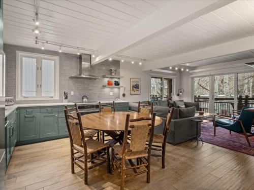 a kitchen and living room with a table and chairs at Lift One Condominiums - Unit 305 in Aspen