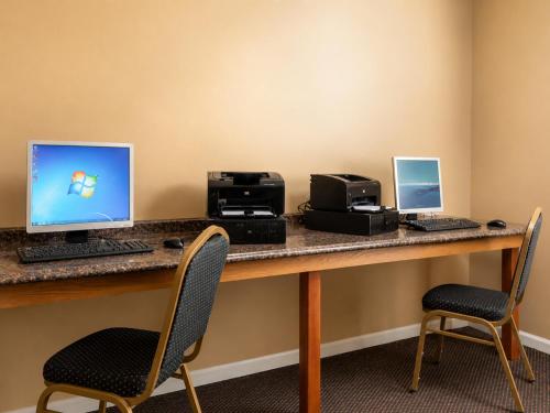 a desk with two computers and printers on it at Carriage Place in Branson