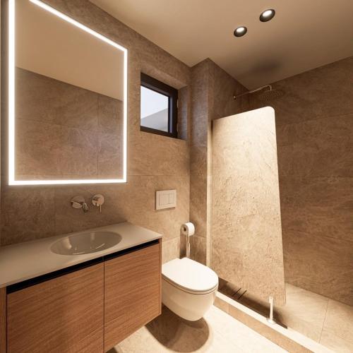 a bathroom with a toilet and a sink and a mirror at Zanetos Prasonisi in Prasonisi