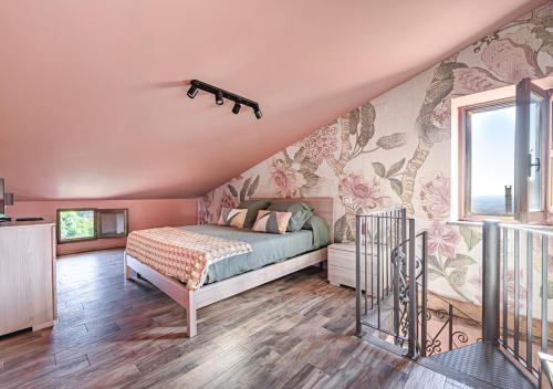 a bedroom with a bed with flowers on the wall at B&B Locanda Cistercense in San Martino al Cimino