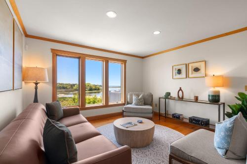 a living room with a couch and a table at Waterfront Escape Game Room Dog Friendly in Chatham