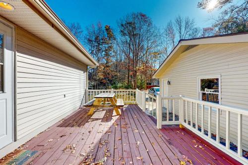 a wooden deck with a bench on the side of a house at The Nest in Ocean Pines