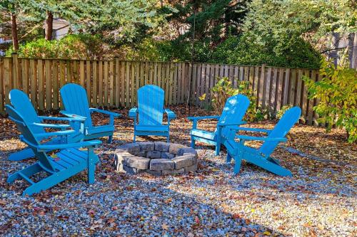 a group of blue chairs sitting around a fire pit at The Nest in Ocean Pines