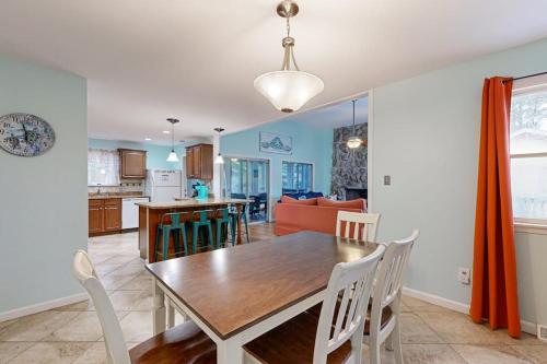 a dining room and kitchen with a table and chairs at Teal Haven in Ocean Pines