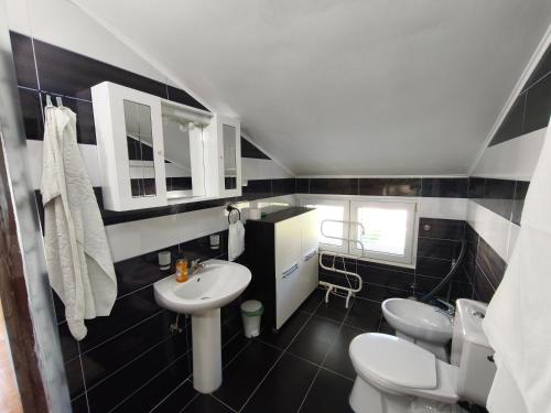 a bathroom with two toilets and a sink at Cozy home in Donja Lastva