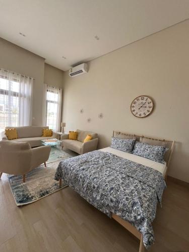 a bedroom with a bed and a clock on the wall at Luxury Salalah Villa in Salalah