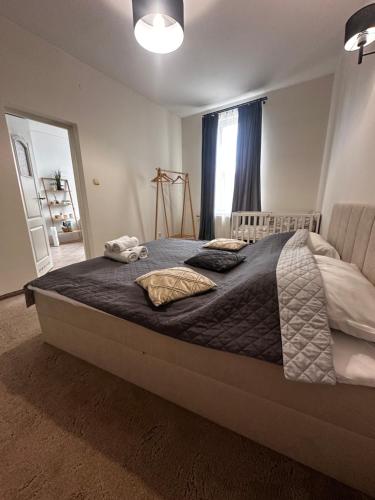 a bedroom with a large bed with pillows on it at Apartament 120m2 Centrum Ostródy in Ostróda