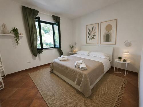 a bedroom with a large bed with towels on it at Il Corbezzolo Tropea Residence in Tropea
