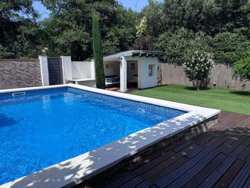 a swimming pool in a yard next to a backyard at HomeHolidaysRentals Confort in La Batlloria