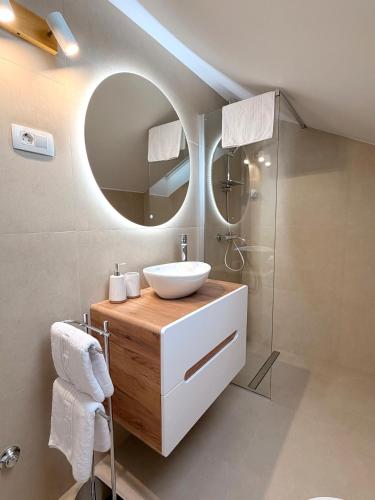 a bathroom with a sink and a mirror at Šaravanja in Bibinje
