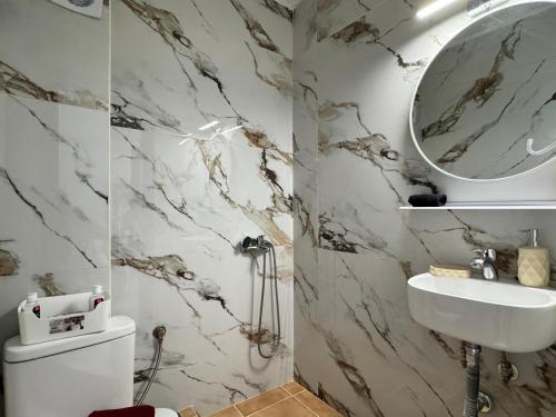 a bathroom with a white sink and a mirror at Siblings by the Sea in Skala Marion