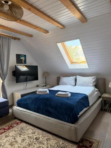 a bedroom with a large bed and a window at Dom Prowansalski in Jaworzynka
