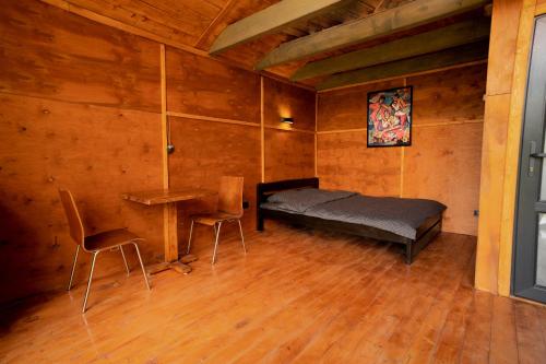 a bedroom with a bed and a table and chairs at Asket Villas in Krivorovnya