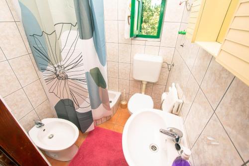 a small bathroom with a sink and a toilet at House Punta in Kraj