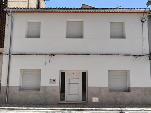 a white building with a door and windows at Casa Bethel in Chella