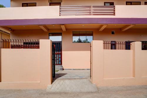 a house with a purple roof at Super Hotel O Dharampur Crossway in Mājra