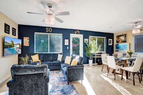 a living room with couches and a dining room at Caribbean Paradise Retreat Private Pool, Outdoor Kitchen & Jacuzzi in Fort Lauderdale