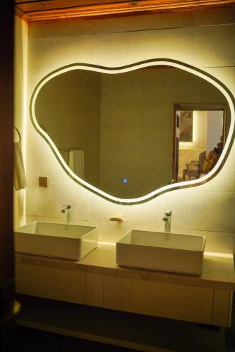 a bathroom with two sinks and a large mirror at Valea Bhurban in Bhurban