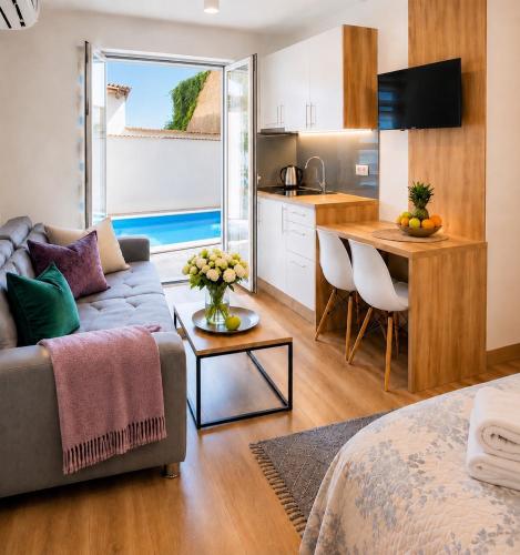 a living room with a couch and a table and a kitchen at Villa Diamond in Mostar