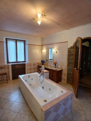 a large bathroom with a large bath tub at Eva house 1 in Fanano