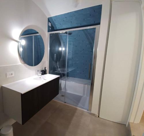 a bathroom with a shower and a sink and a mirror at Radici 1892 in Montescaglioso
