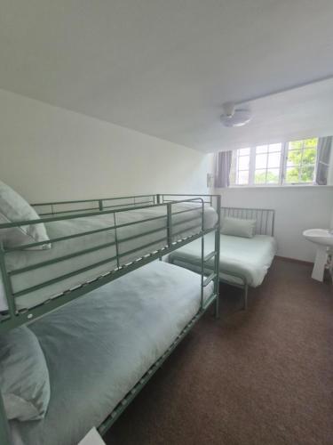 a room with two bunk beds and a sink at Ty Bert in Newport