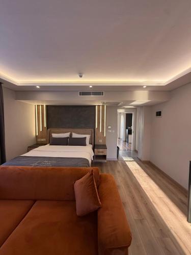 a bedroom with a large bed and a couch at North Star Resort Hotel in Of