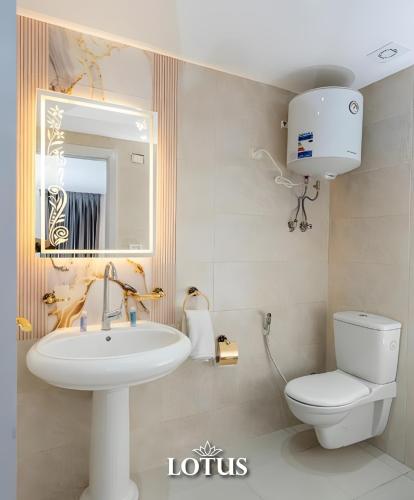 a bathroom with a white toilet and a sink at Lotus Hotel l Downtown Cairo Sq in Cairo