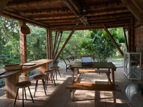 a screened in porch with a table and chairs at Maskani Wasi in Lago Agrio
