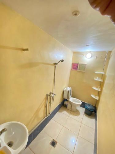 a bathroom with two sinks and a toilet and a shower at maison isabel in Boumalne Dades