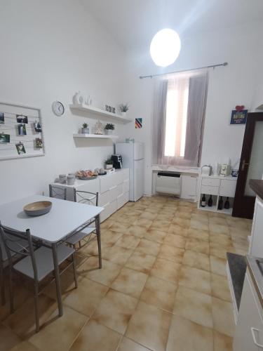 a kitchen with a table and a table and chairs at A casa di Irene in Le Marmore