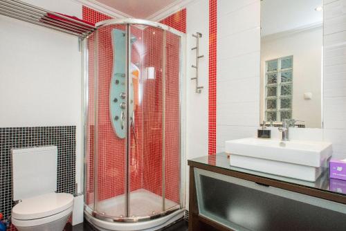 a bathroom with a shower and a toilet and a sink at Find Me Inn Alcantara in Lisbon