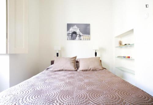 a bed in a white room with a large bed at Find Me Inn Alcantara in Lisbon