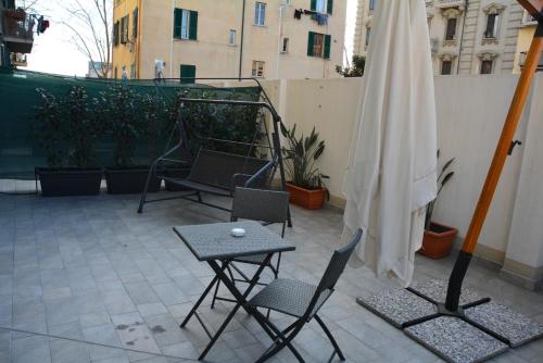 a patio with two chairs and a table and an umbrella at Le Veneri Del Golfo in La Spezia