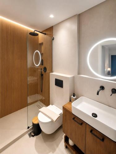 a bathroom with a toilet and a sink at Aura di centro Thassos in Limenas
