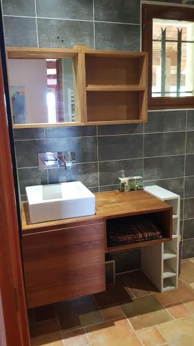 a bathroom with a sink and a mirror at Au Royaume des Chats in Soudorgues
