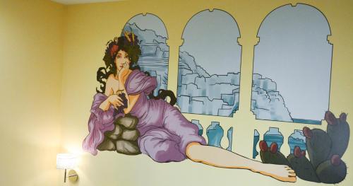 a mural of a woman on a wall in a room at Le Veneri Del Golfo in La Spezia