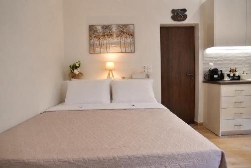 a bedroom with a large bed with white pillows at Nook Athens Airport in Spata