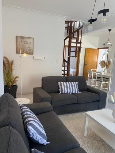 a living room with a couch and a table at Evelyn House in Samos