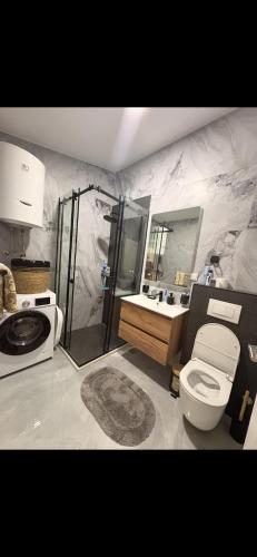 a bathroom with a shower and a toilet and a sink at Sea&Forest view in Buljarica