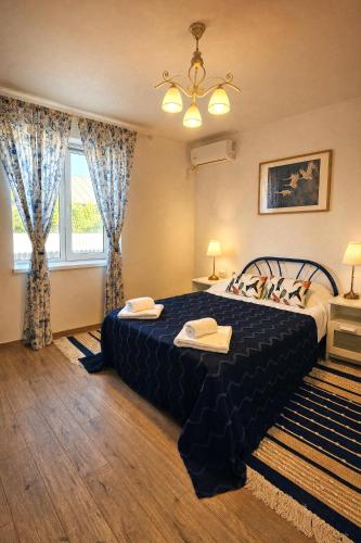 a bedroom with a large bed and a window at Căsuța Sofia in Sulina