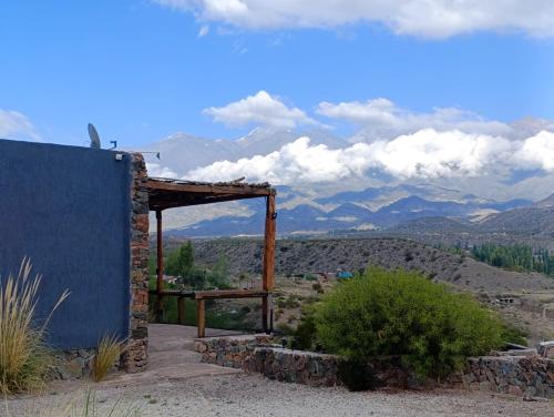 a building in the desert with mountains in the background at Tierra Potrerillos in Potrerillos