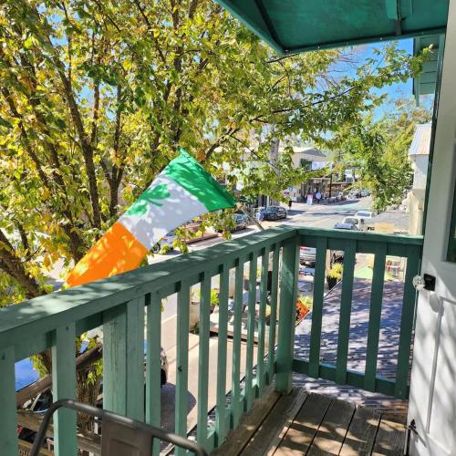 a flag sitting on a railing on a porch at Terrace On Main Street in Murphys