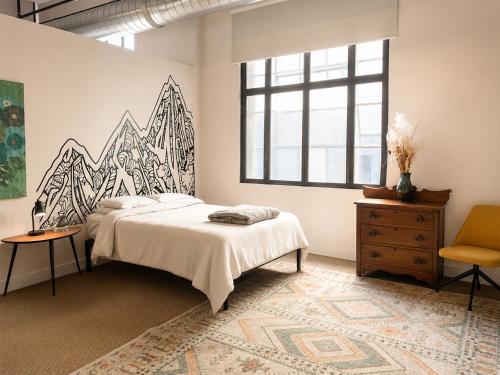 a bedroom with a bed and a large window at Hostel du Nord in Duluth