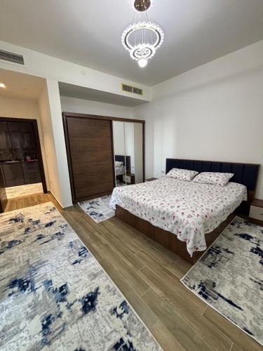 a bedroom with a bed and two rugs at New Alamen Towers in El Alamein